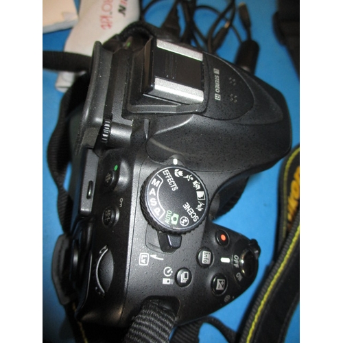 113 - A pre-owned Nikon D5200 camera with 2 lenses, in current working order with charger, leads and kit b... 