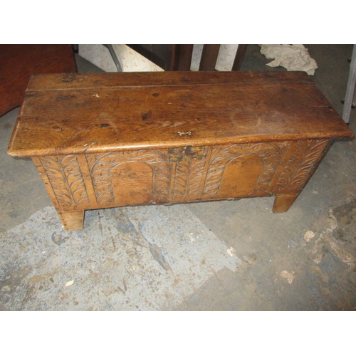 114 - An antique oak coffer, carved decoration to front, age related repairs and marks. Approximate sizes,... 