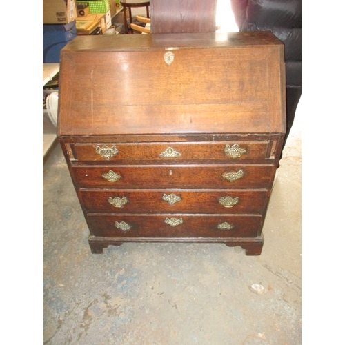 116 - An antique oak bureau with manual loapers and 4 long graduated drawers. Age related marks and repair... 