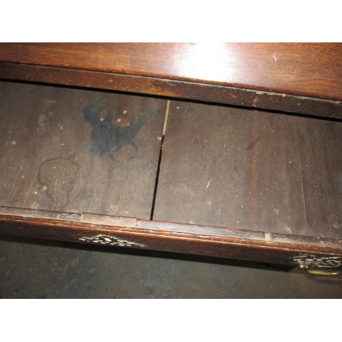 116 - An antique oak bureau with manual loapers and 4 long graduated drawers. Age related marks and repair... 