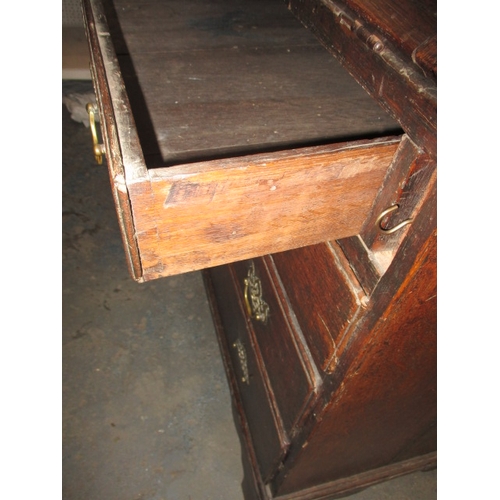 116 - An antique oak bureau with manual loapers and 4 long graduated drawers. Age related marks and repair... 