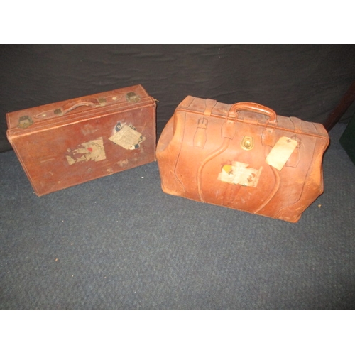 217 - A vintage leather gladstone bag and a small leather suit case, both in used condition