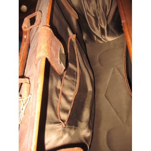 217 - A vintage leather gladstone bag and a small leather suit case, both in used condition