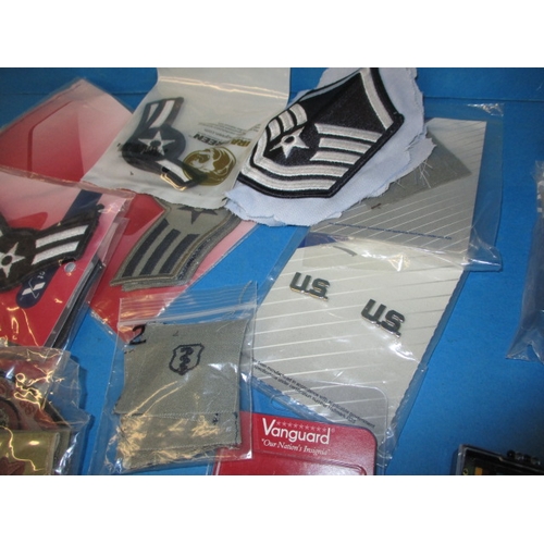 225 - A quantity of US Air Force metal and cloth badges. Most in original packaging