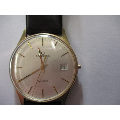 74 - A 1980s gold cased quartz watch with Garrard retailers to dial, dedication to back of case, crown mi... 