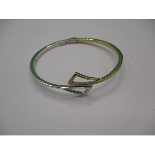 45 - A 9ct yellow and white gold bangle, in good useable pre-owned condition, approx. weight 10.9g