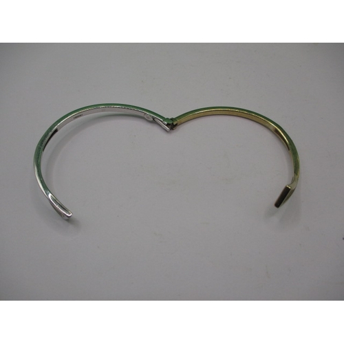 45 - A 9ct yellow and white gold bangle, in good useable pre-owned condition, approx. weight 10.9g