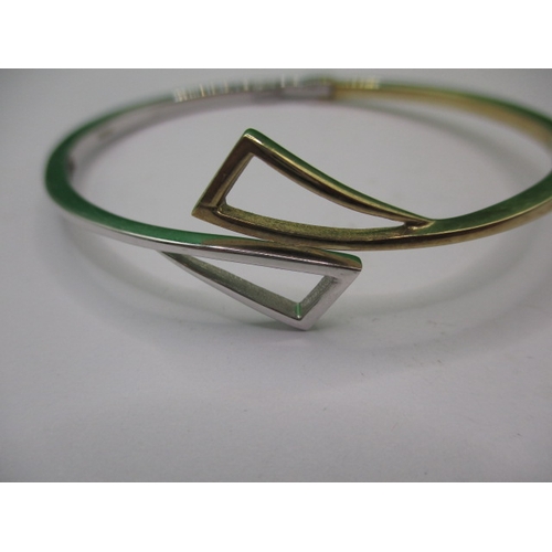 45 - A 9ct yellow and white gold bangle, in good useable pre-owned condition, approx. weight 10.9g