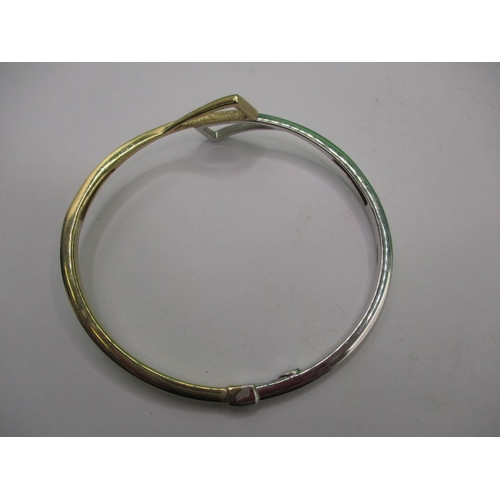 45 - A 9ct yellow and white gold bangle, in good useable pre-owned condition, approx. weight 10.9g