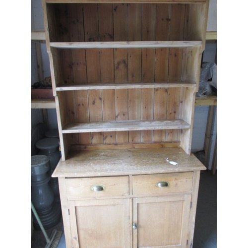 318 - An early 20th Century stripped pine kitchen dresser. In useable, pre-owned condition with age relate... 