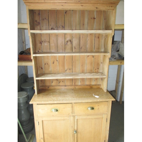 318 - An early 20th Century stripped pine kitchen dresser. In useable, pre-owned condition with age relate... 