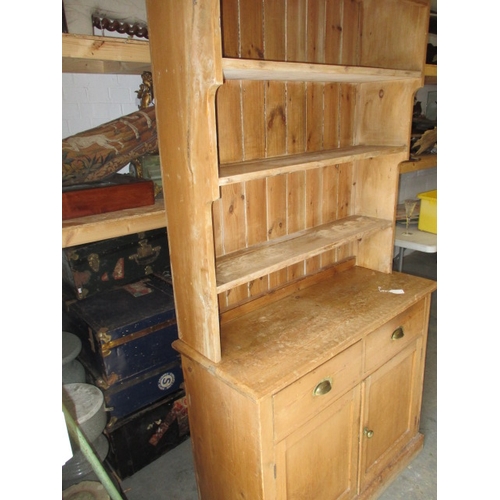 318 - An early 20th Century stripped pine kitchen dresser. In useable, pre-owned condition with age relate... 