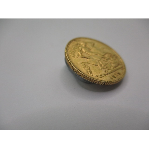 97 - A George V gold half sovereign dated 1913, a circulated coin with very fine definition of features