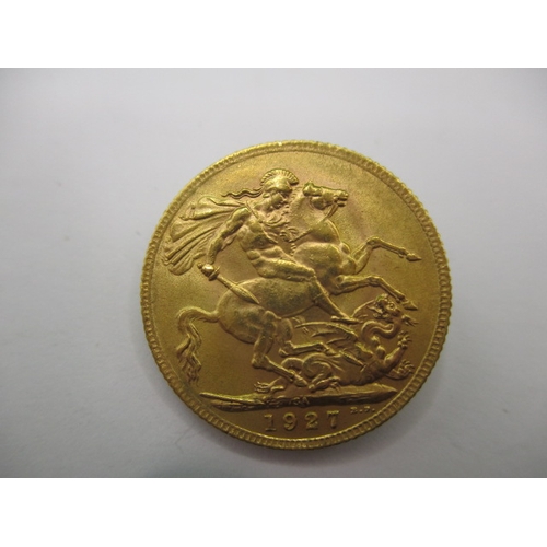 125 - A George V full gold sovereign dated 1927, a circulated coin with very fine definition of features