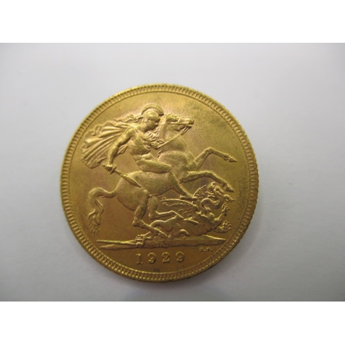 126 - A George V full gold sovereign dated 1929, a near uncirculated coin with very fine definition of fea... 