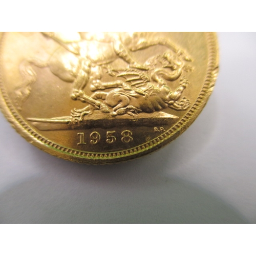 128 - An Elizabeth II  full gold sovereign dated 1958, a circulated coin with very fine definition of feat... 