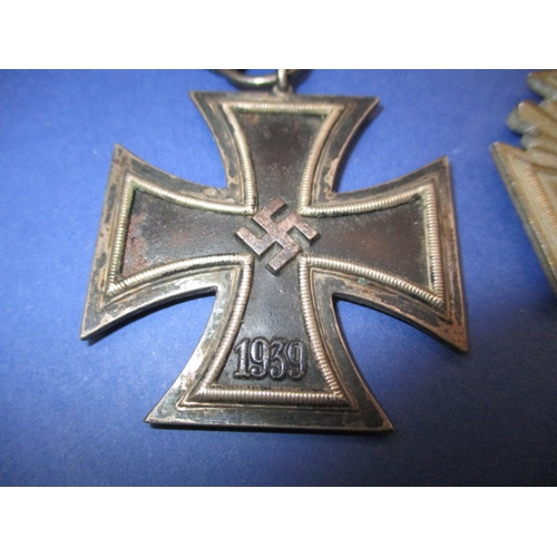 255 - Three German medals to include WWI iron cross WWII iron cross and a Third Reich NSDAP 10 year servic... 