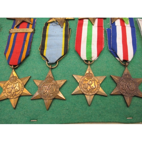 257 - A collection of 10 vintage military medals, 8 stars mounted on display board, 2 Russian medals in po... 