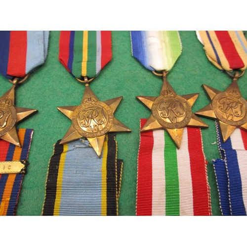 257 - A collection of 10 vintage military medals, 8 stars mounted on display board, 2 Russian medals in po... 