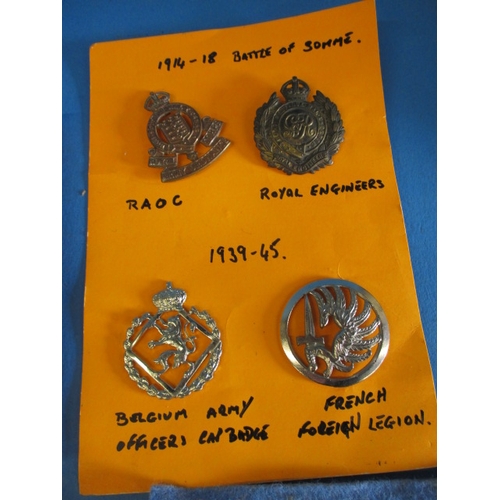 258 - A parcel of military metal and cloth badges, and a 1945 Lancaster 1/111 handling drills booklet, all... 