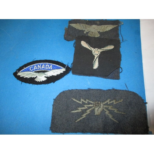 258 - A parcel of military metal and cloth badges, and a 1945 Lancaster 1/111 handling drills booklet, all... 