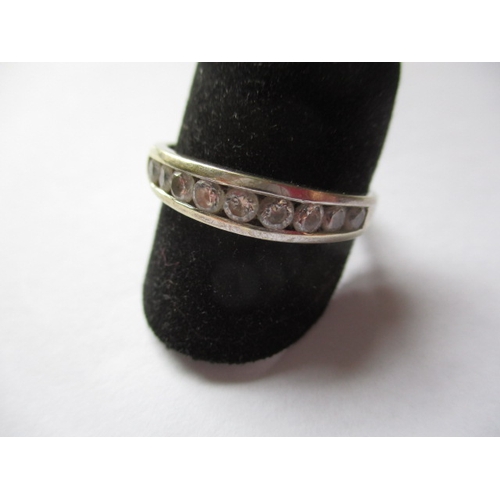 21 - A 9ct white gold and CZ half eternity ring, approx. ring size ‘V’, approx. weight 2.6g in useable pr... 