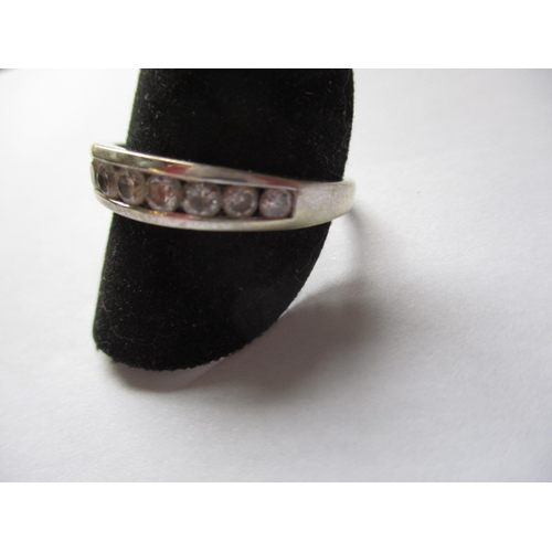 21 - A 9ct white gold and CZ half eternity ring, approx. ring size ‘V’, approx. weight 2.6g in useable pr... 