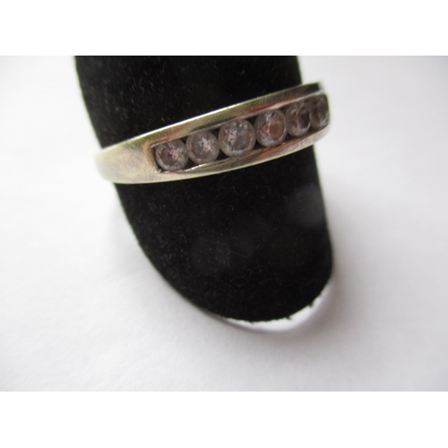 21 - A 9ct white gold and CZ half eternity ring, approx. ring size ‘V’, approx. weight 2.6g in useable pr... 