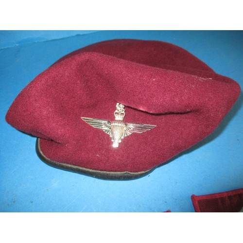 262 - Two post was parachute regiment berets with cap badges and associated cloth badges, in good pre-owne... 