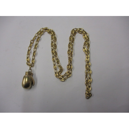 53 - A gold necklace chain with boxing glove pendant, pendant marked for 9ct the chain un-marked but beli... 