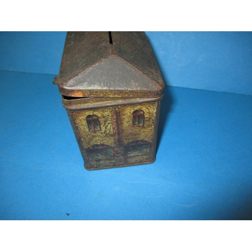 250 - A vintage biscuit tin in the form of a bank money box, having reasonable amount of decoration and or... 