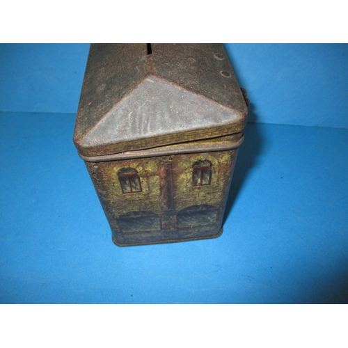 250 - A vintage biscuit tin in the form of a bank money box, having reasonable amount of decoration and or... 