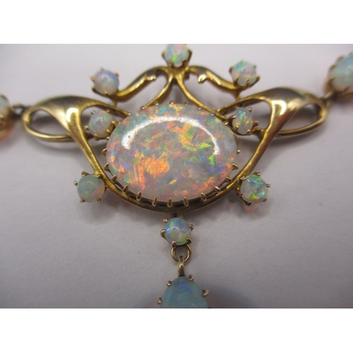 56 - A late 19th century 15ct gold and opal necklace, having 12 fire opals, the central stone measuring a... 