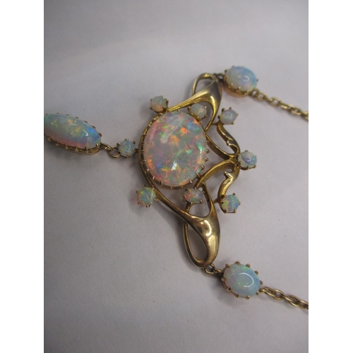 56 - A late 19th century 15ct gold and opal necklace, having 12 fire opals, the central stone measuring a... 