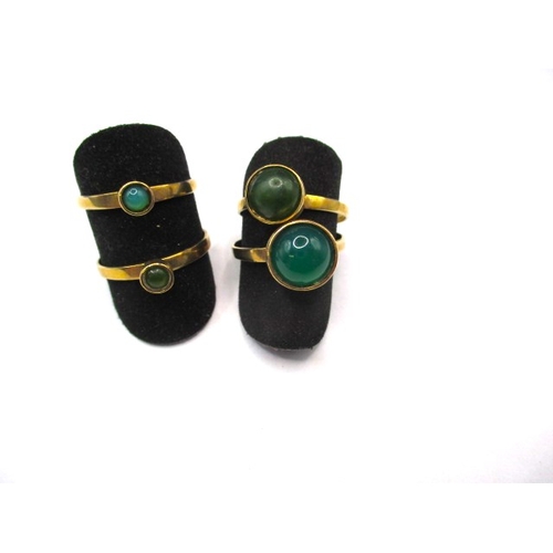 40 - A set of four 9ct gold rings, each set with a cabochon green stone of various sizes, approx. ring si... 