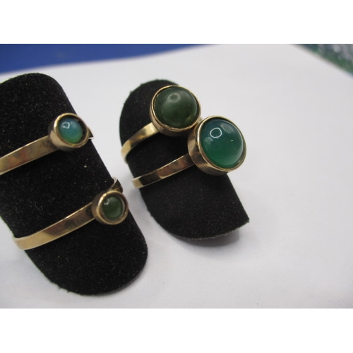 40 - A set of four 9ct gold rings, each set with a cabochon green stone of various sizes, approx. ring si... 