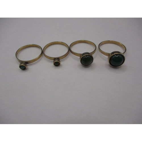 40 - A set of four 9ct gold rings, each set with a cabochon green stone of various sizes, approx. ring si... 