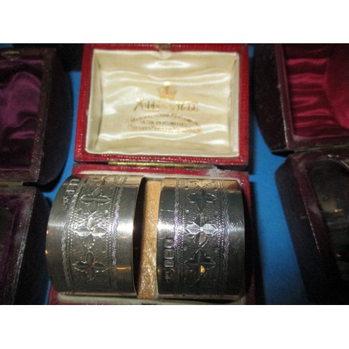 189 - A parcel of antique and later  sterling silver napkin rings, to include several pairs, all in boxes,... 