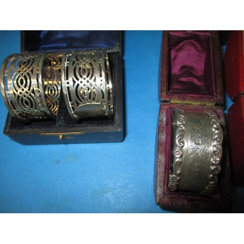 189 - A parcel of antique and later  sterling silver napkin rings, to include several pairs, all in boxes,... 