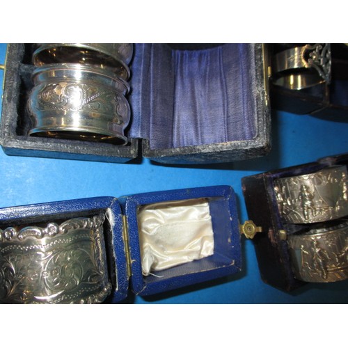 189 - A parcel of antique and later  sterling silver napkin rings, to include several pairs, all in boxes,... 