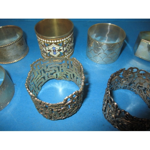 194 - A parcel of antique and later silver and white metal napkin rings, to include some enamelled example... 