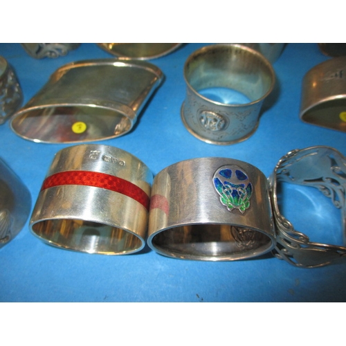 195 - A parcel of antique and later silver and white metal napkin rings, to include some enamelled example... 