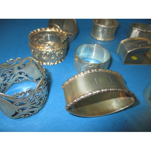 195 - A parcel of antique and later silver and white metal napkin rings, to include some enamelled example... 