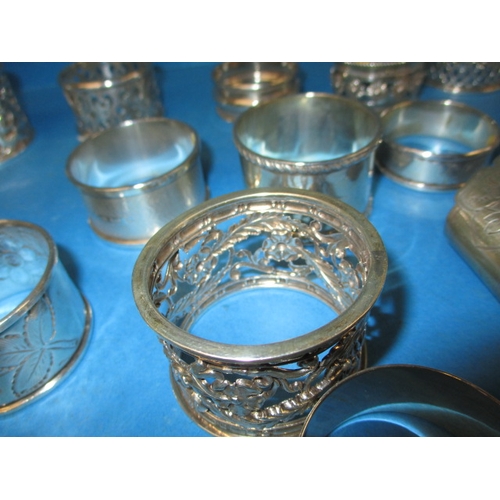 168 - A parcel of antique and later silver and white metal napkin rings, to include some enamelled example... 