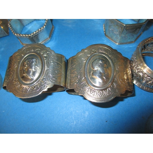 201 - A parcel of antique and later silver and white metal napkin rings, various makers and dates, all in ... 