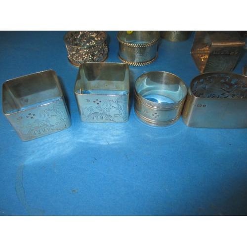 201 - A parcel of antique and later silver and white metal napkin rings, various makers and dates, all in ... 