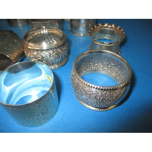 201 - A parcel of antique and later silver and white metal napkin rings, various makers and dates, all in ... 