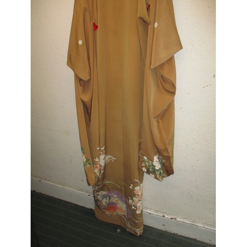 321 - A beige silk Japanese kimono, with original wrapping. In used condition with a few loose threads and... 