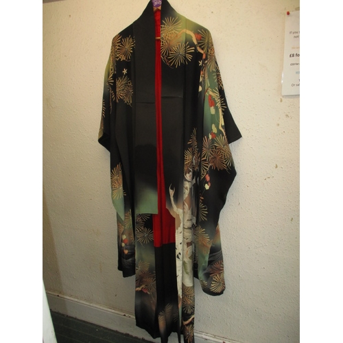 322 - A black silk Japanese kimono. In used condition with a few loose threads and wear. Approximate lengt... 