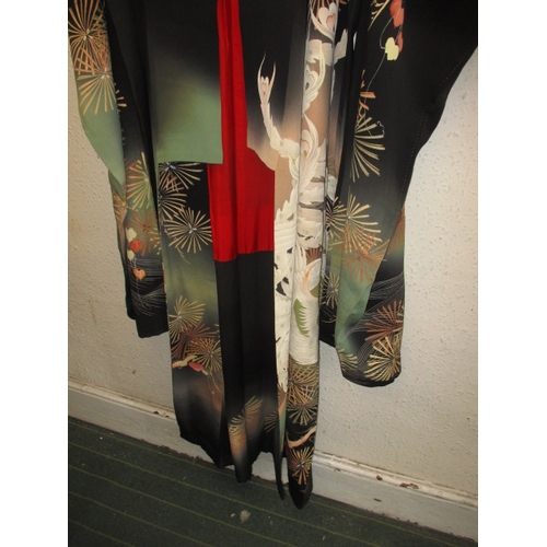 322 - A black silk Japanese kimono. In used condition with a few loose threads and wear. Approximate lengt... 